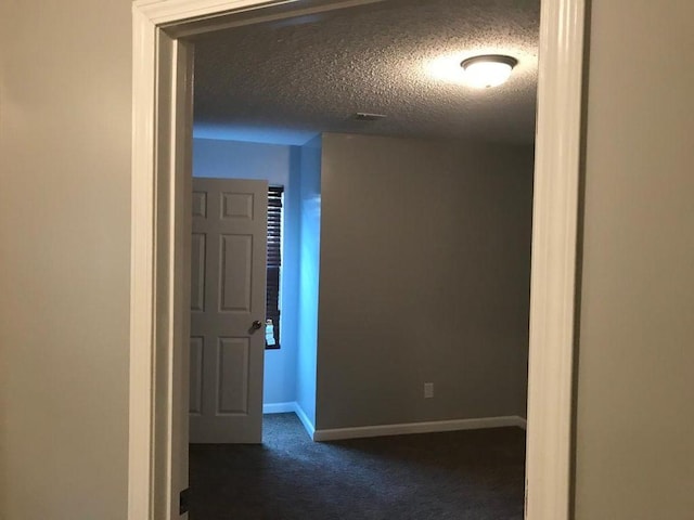 2103 Campground Road, Munford, TN 38058 - hallway featuring dark colored carpet and a textured ceiling