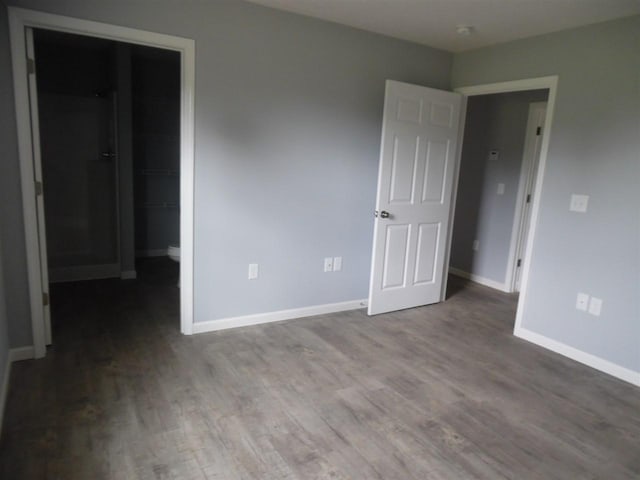 unfurnished room with dark hardwood / wood-style flooring