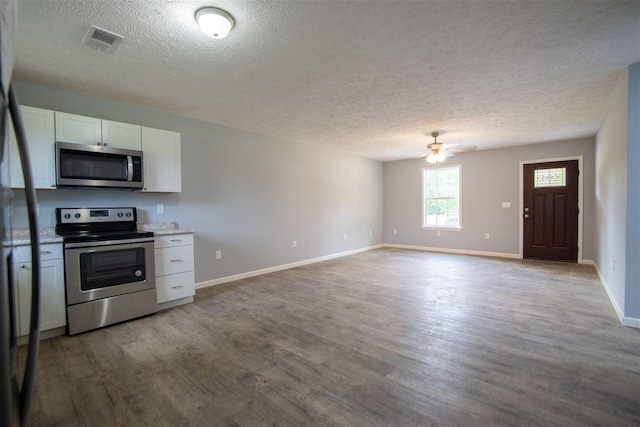 kitchen featuring appliances with stainless steel finishes, white cabinetry, light hardwood / wood-style flooring, ceiling fan, and a textured ceiling