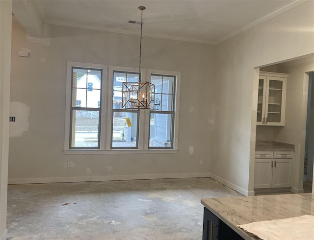 unfurnished dining area with crown molding, a notable chandelier, and a wealth of natural light