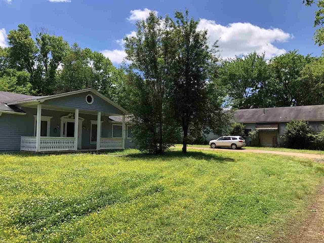 view of yard featuring covered porch