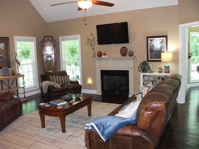 living room with ceiling fan, light wood-type flooring, and vaulted ceiling