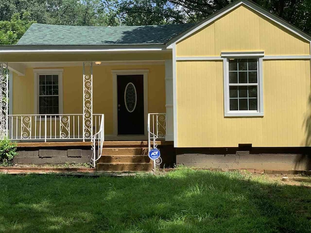 view of front of property with a front yard and a porch