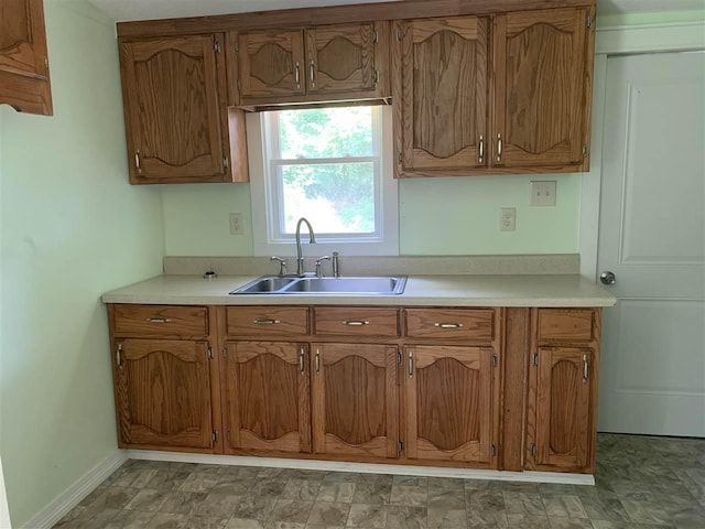 kitchen with sink and light tile floors