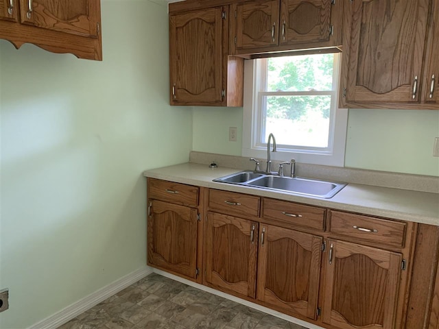 kitchen featuring dark tile flooring and sink