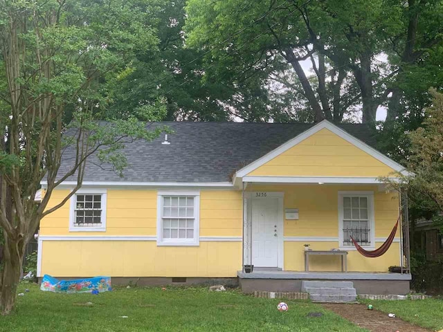 view of front facade with a front yard and a porch