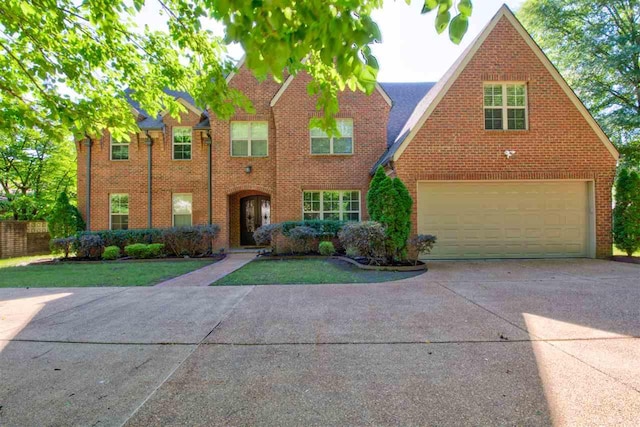 view of front facade with a front yard and a garage