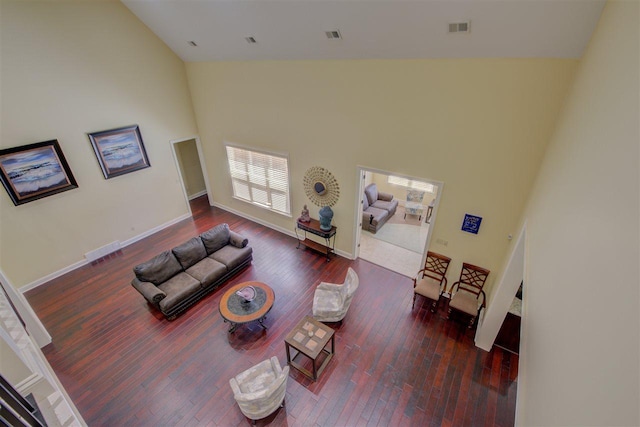 living room with high vaulted ceiling and dark hardwood / wood-style floors