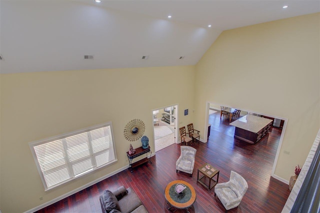 living room featuring dark hardwood / wood-style flooring and high vaulted ceiling