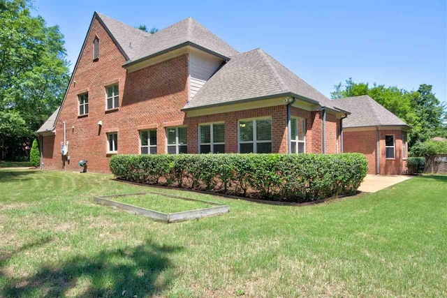 view of side of property with a lawn