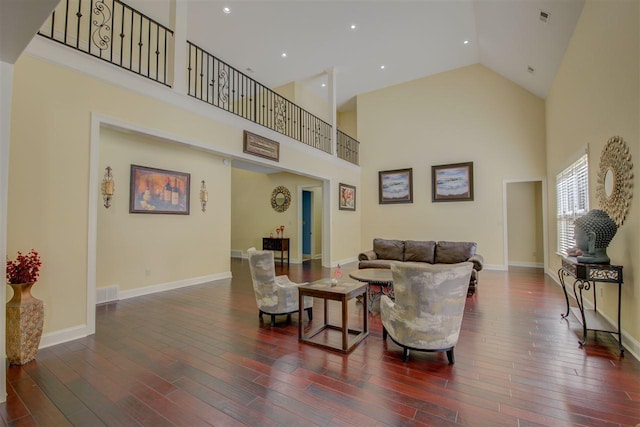 living room featuring high vaulted ceiling and dark wood-type flooring