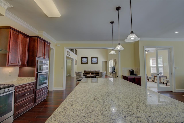 kitchen with pendant lighting, light stone counters, stove, stainless steel double oven, and dark hardwood / wood-style flooring