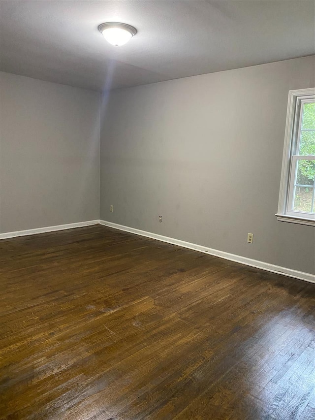 spare room with dark hardwood / wood-style floors