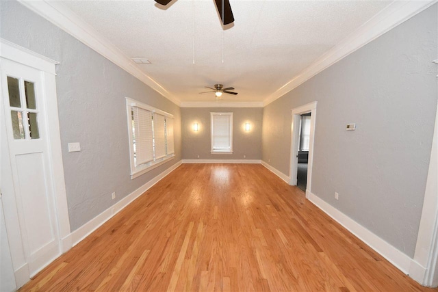 unfurnished room with ceiling fan, crown molding, and light wood-type flooring