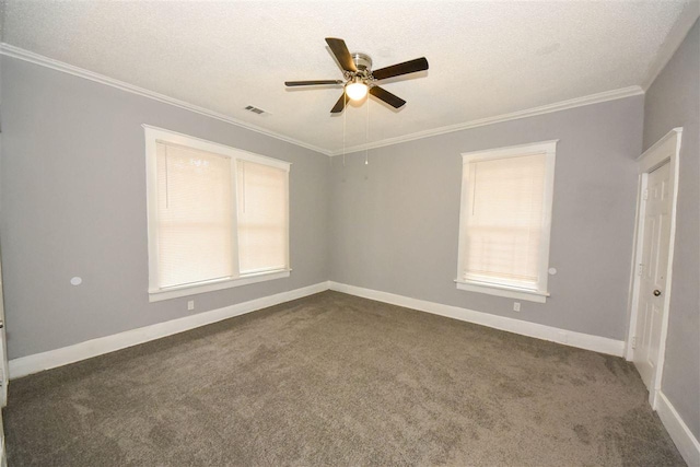 empty room featuring ceiling fan, ornamental molding, dark carpet, and a textured ceiling