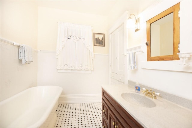 bathroom with a bath to relax in, vanity with extensive cabinet space, and tile flooring