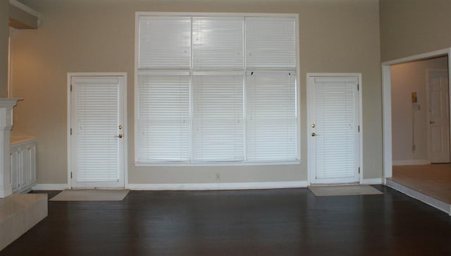 unfurnished living room with dark hardwood / wood-style floors