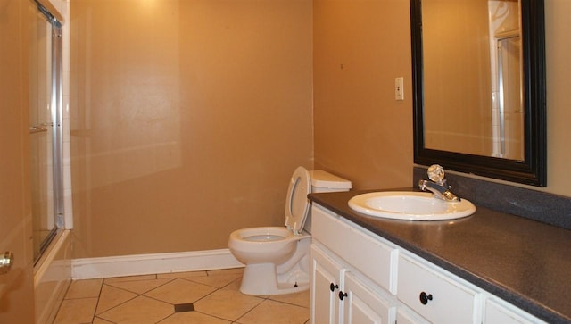 full bathroom featuring shower / bath combination with glass door, tile floors, toilet, and vanity