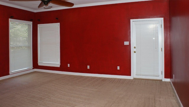 empty room with carpet flooring, ceiling fan, and ornamental molding