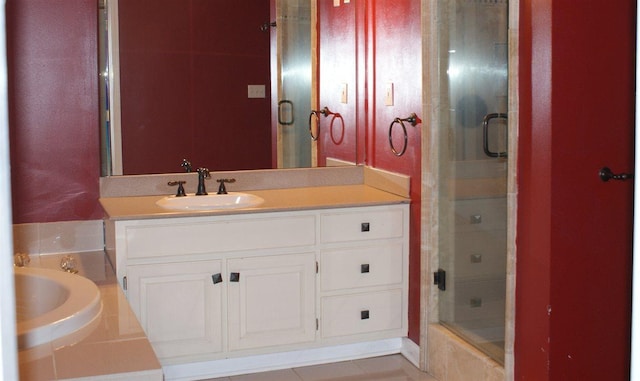 bathroom featuring separate shower and tub, vanity, and tile flooring