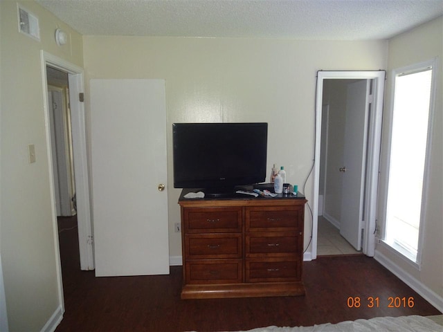 tiled bedroom with a textured ceiling