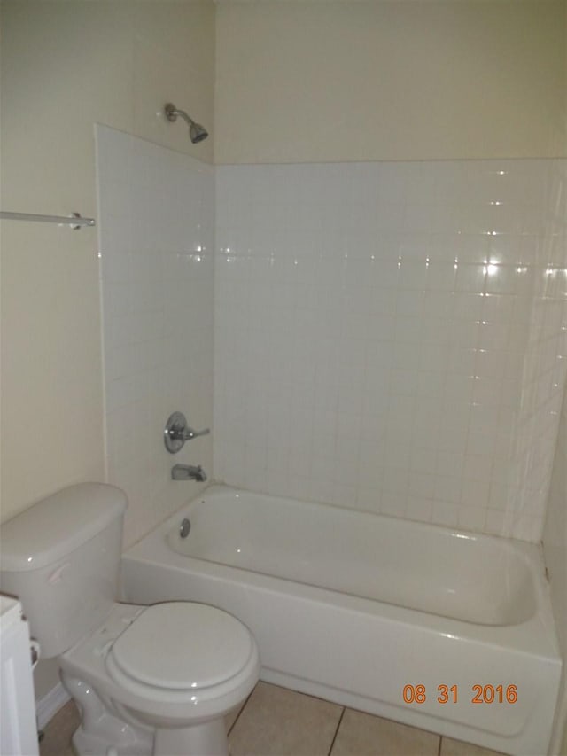 full bathroom featuring vanity, tile floors, toilet, and tiled shower / bath