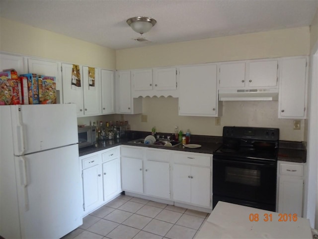 kitchen featuring light tile flooring, white fridge, range, sink, and white cabinets