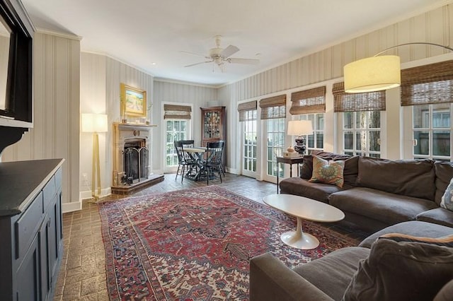 living room featuring ornamental molding and ceiling fan