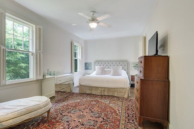 bedroom with ceiling fan and dark hardwood / wood-style floors