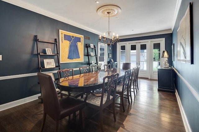 dining area featuring an inviting chandelier, crown molding, dark hardwood / wood-style floors, and french doors