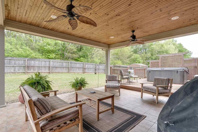 view of patio featuring ceiling fan and a hot tub