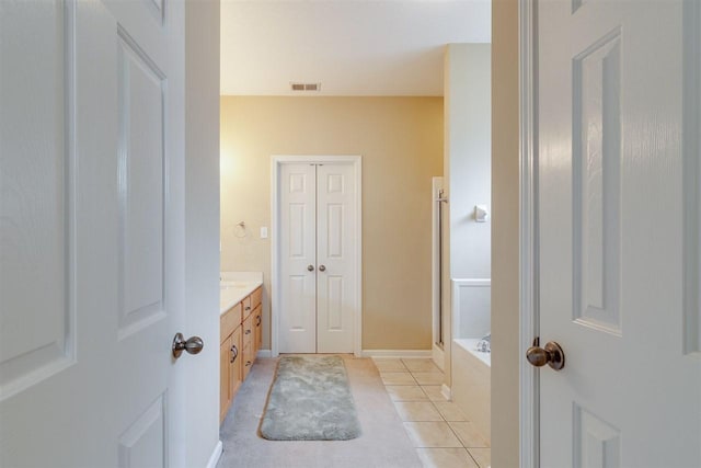 bathroom with tile floors and vanity