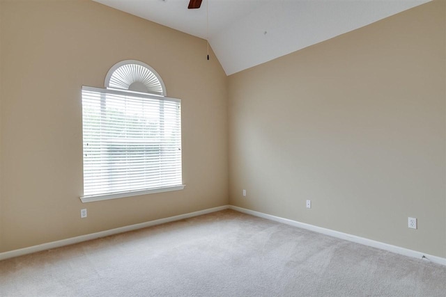 carpeted empty room featuring ceiling fan and lofted ceiling