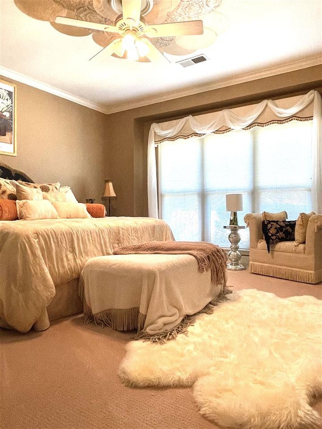 carpeted bedroom featuring crown molding and ceiling fan