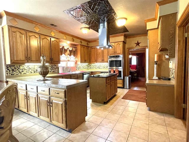 kitchen with crown molding, a kitchen island, backsplash, and island range hood