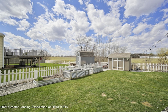 4246 Black Cherry Ln, Mason, MI 48854 - fenced backyard featuring a storage unit, a garden, a wooden deck, and stairs