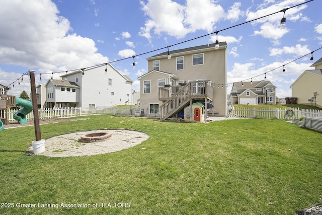 4246 Black Cherry Ln, Mason, MI 48854 - back of house featuring a fire pit, stairs, a fenced backyard, and a residential view