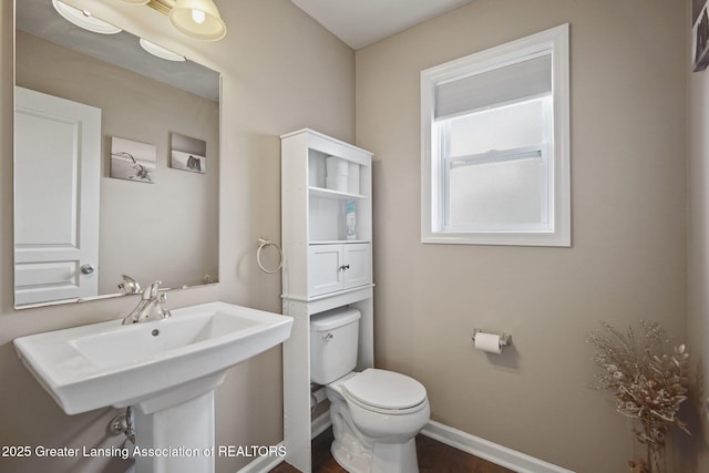 4246 Black Cherry Ln, Mason, MI 48854 - half bath with toilet and wood finished floors