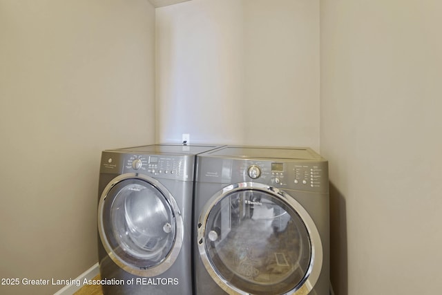 4246 Black Cherry Ln, Mason, MI 48854 - laundry room featuring washing machine and dryer and baseboards