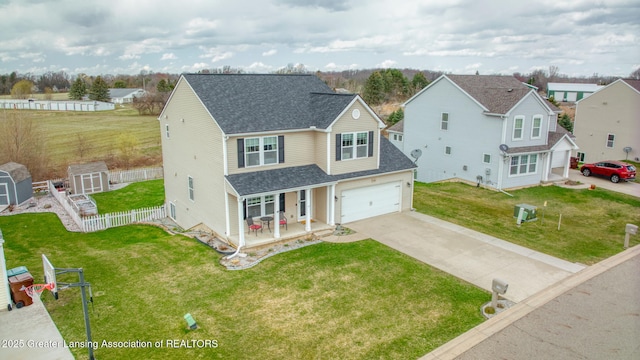 4246 Black Cherry Ln, Mason, MI 48854 - traditional home with covered porch, concrete driveway, a shingled roof, a garage, and a shed