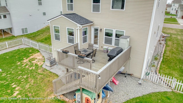 4246 Black Cherry Ln, Mason, MI 48854 - back of property with a wooden deck, a fenced backyard, and outdoor lounge area