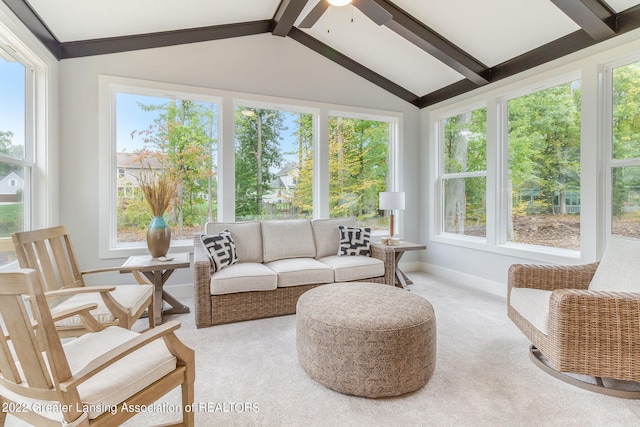 sunroom featuring ceiling fan and lofted ceiling with beams