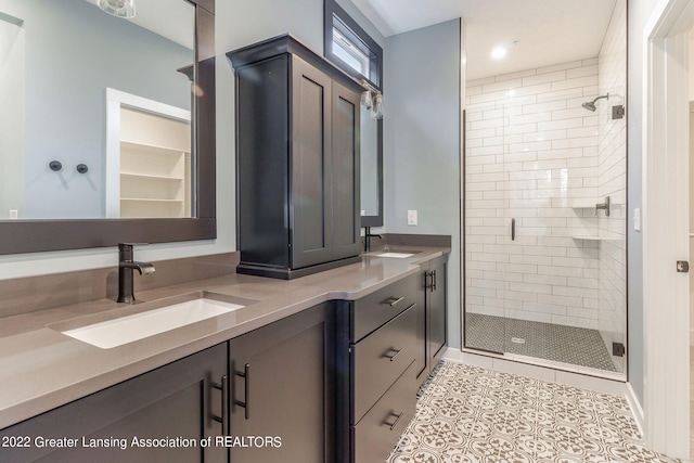 bathroom featuring tile floors, a shower with shower door, and dual bowl vanity