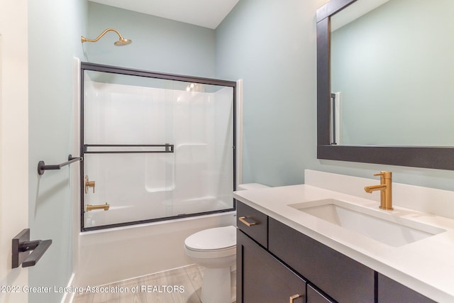 full bathroom with toilet, shower / bath combination with glass door, vanity, and tile flooring