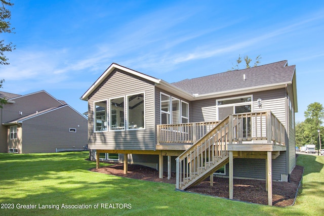 back of house featuring a wooden deck and a lawn