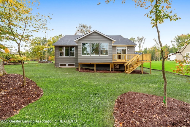 back of house featuring a deck and a lawn