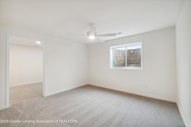 unfurnished room featuring light colored carpet and ceiling fan