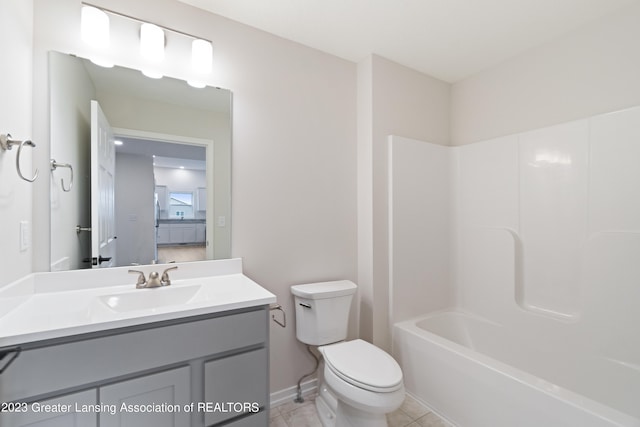 full bathroom with  shower combination, tile flooring, large vanity, and toilet