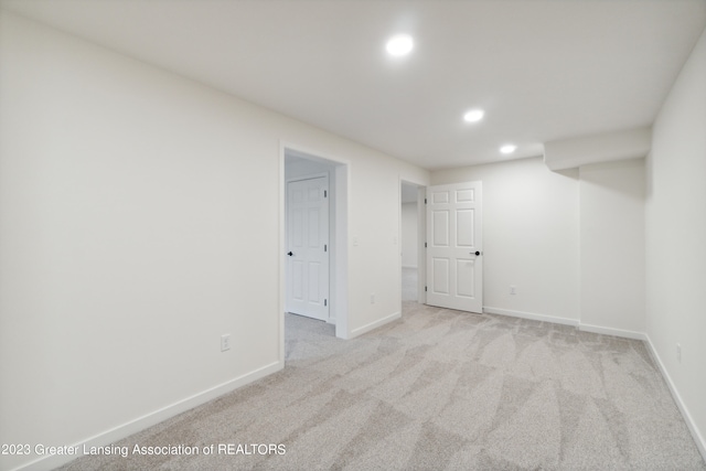 spare room featuring light colored carpet