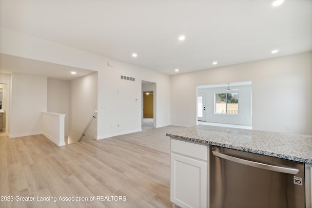 kitchen featuring white cabinets, light stone countertops, dishwasher, and light wood-type flooring